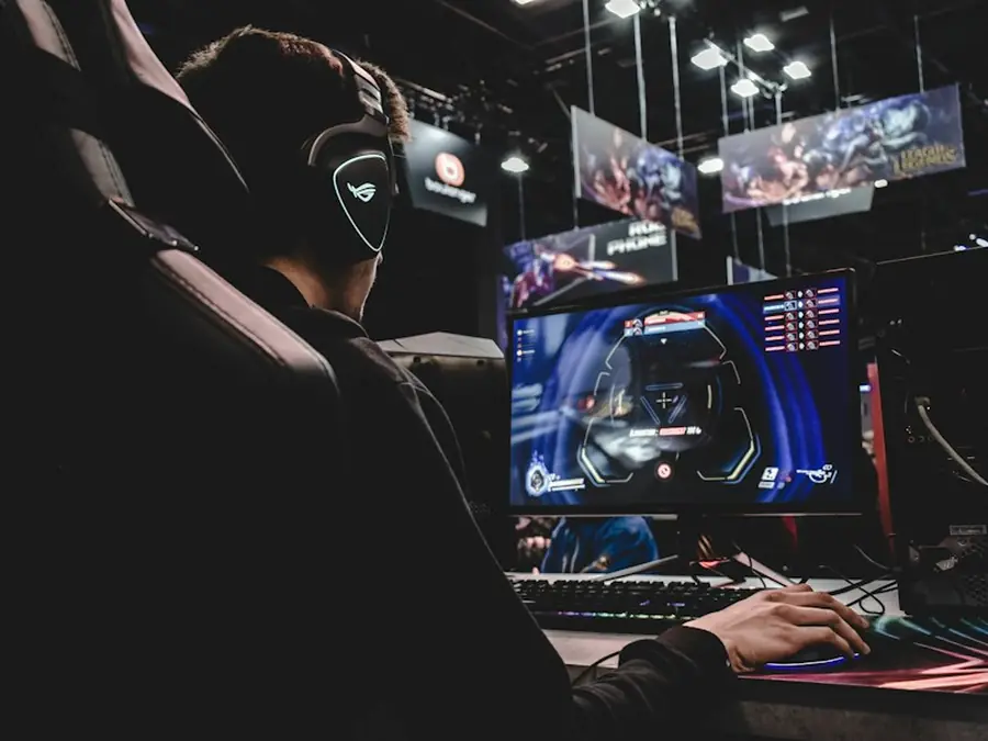 Gamer playing at a lit gaming setup